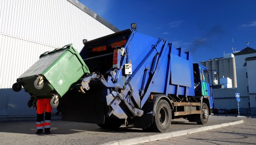 Waterloo skip hire service truck loading a skip
