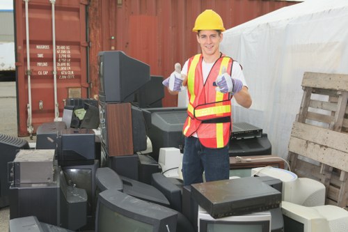 Business team using a commercial skip for waste disposal