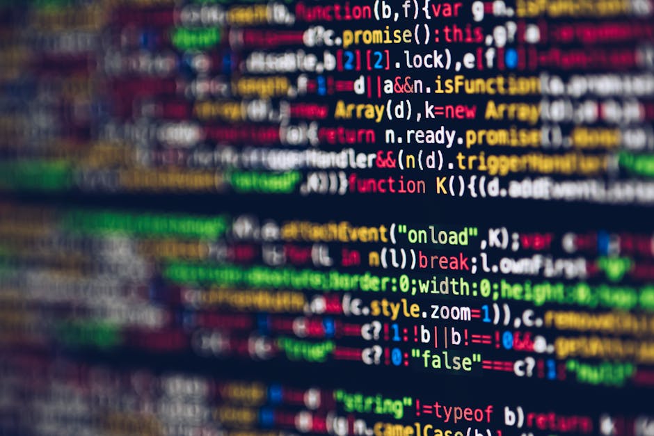 A close-up view of a computer screen displaying a dense, colorful array of programming code with lines of text in various shades of red, yellow, green, blue, and white. The code appears to be written